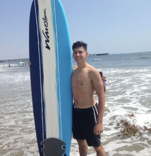Portrait photo of Nicholas Herrera at the beach catching some waves for the day. Herrera trying to be fit during these unfortunate times. Photo credit: courtesy of Nicholas Herrera