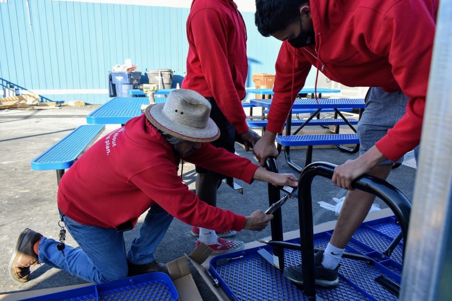 Mercy House staff putting a table together for the facilitys common area. This is where facility residence will receive their three meals a day. 