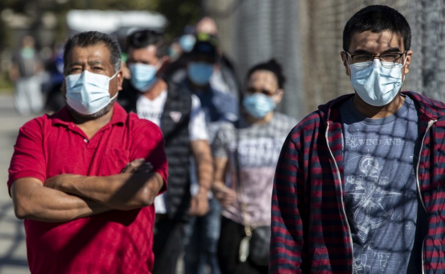 SAN FERNANDO, CA - DECEMBER 01: People wait in line at a walk-up Covid-19 testing site at San Fernando Recreation Park Tuesday, Dec. 1, 2020 in San Fernando, CA. (Brian van der Brug / Los Angeles Times)