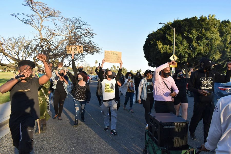 Activists march to celebrate Black History Month and African-Americans role in shaping American history. They marched through Marina Park in Long Beach on Feb. 20, 2021.