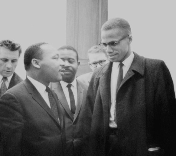 Martin Luther King and Malcolm X waiting for press conference. People celebrate King while denigrating X but both held radical visions for a different America.
