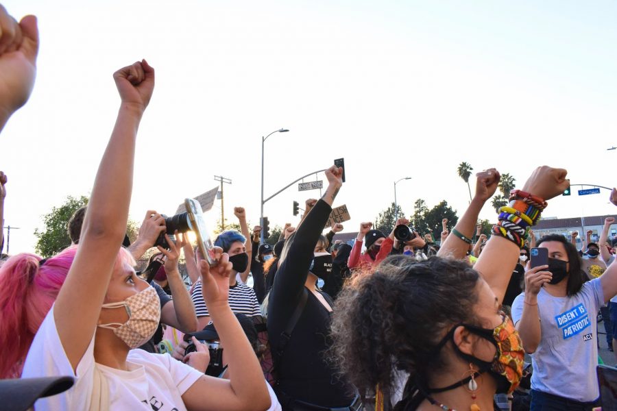 BLM speakers asked their rally participants to raise their fists as they called for the defunding of police during a rally on Feb. 24, 2021. 