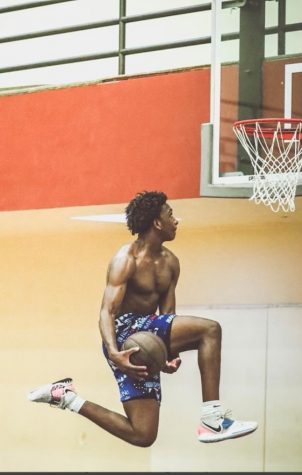 Joshua Belvin goes up for a between-the-legs dunk while playing basketball at his local gym. Belvin is excited to start conditioning on campus and is more than prepared for the upcoming season. Photo credit: Courtesy of Joshua Belvin