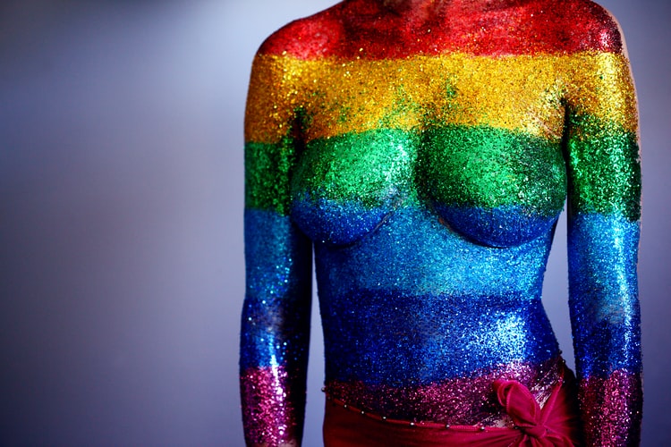 A woman covered in glitter in support of the LGBTQ+ community. These colors represent diversity and unity within the community. 