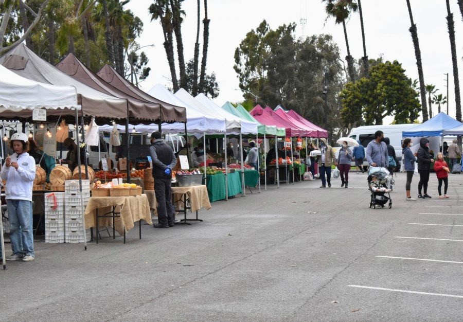 Customers shop at the Local Harvest Farmers Market in Long Beach on March 4, 2021. They supported the vendors and small businesses that sold organic produce. 