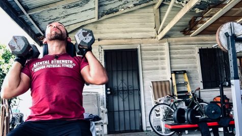 Rincon works out on Mar. 12 at his home gym. His shirt represents his belief that physical fitness can help with mental health and strength.