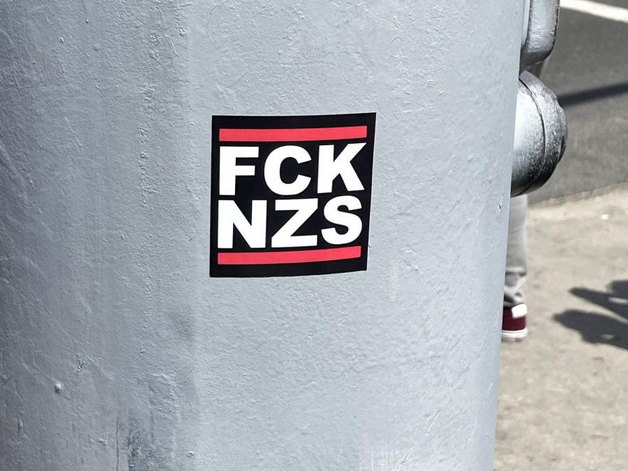 An antifascist sticker left by antiracist protesters in opposition to the white supremacist protest. Some right-wing agitators came to Huntington Beach sporting Nazi imagery tattoos on April 11, 2021.