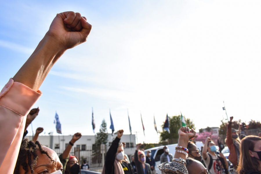 BLM supporters raise their fists in solidarity as the Wednesday-annual protest comes to an end. They held the demonstration in front of the LA PPL on April 14, 2021. 