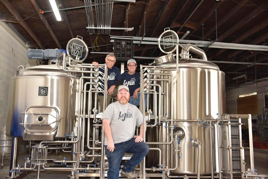 Rudolph Randy Johnstone (left), Derek Johnstone (right), and Jason Sullivan (middle) stand in front of their new fermenters at La Jara Brewing Co. They hope to begin brewing and open by Summer 2021. Photo credit: Courtesy of Derek Johnstone