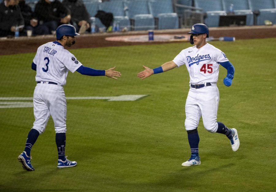 The Los Angeles Dodgers Chris Taylor (3) and Matt Beaty (45) celebrate after they both scored on a two-run single by Corey Seager against the San Diego Padres in the sixth inning at Dodger Stadium on Saturday, April 24, 2021 in Los Angeles. Photo credit: Gina Ferazzi/Los Angeles Times/TNS