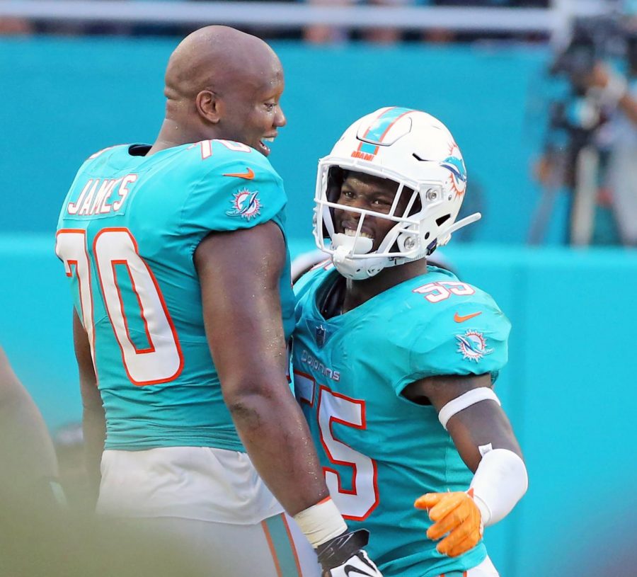 Miami Dolphins JaWuan James (70) celebrates with Jerome Baker (55) after Bakers interception to help seal their victory over the New York Jets on Sunday, Nov. 4, 2018 at Hard Rock Stadium in Miami Gardens, Fla. Photo credit:  Charles Trainor Jr./Miami Herald/TNS