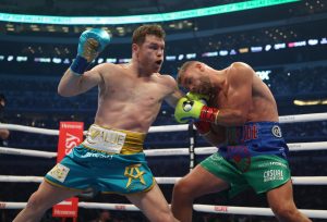 Canelo Alvarez punches Billy Joe Saunders during their fight for Alvarezs WBC and WBA super middleweight titles and Saunders WBO super middleweight title at ATandT Stadium on Saturday, May 8, 2021 in Arlington, Texas. (Al Bello/Getty Images/TNS)
