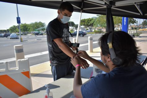 Cerritos College student confirms he has no symptoms of COVID-19 at a health screening kiosk. The college reported that 39 cases of COVID were found on campus as of Sept. 16, 2021. 