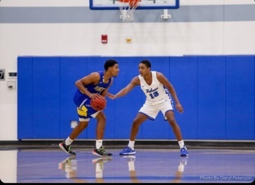 Jahlen on the right blocking another player. Photo credit: Courtesy of Daryl Peterson & sports information