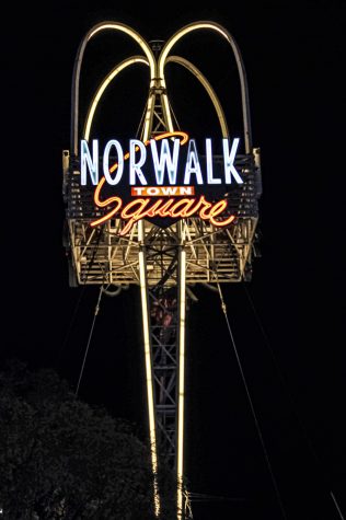 Norwalk Town Square sign that stands tall in the city of Norwalk. The sign lights up in the night as it displays in the center of the Norwalk Community on April. 26th, 2020 