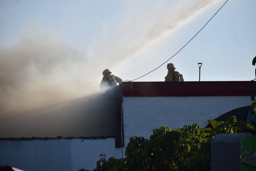 LA County fire fighters pour water into the storage facility to put out the fire in Bellflower. They declare the blaze a thrid-alarm fire on Nov. 9, 2021. 