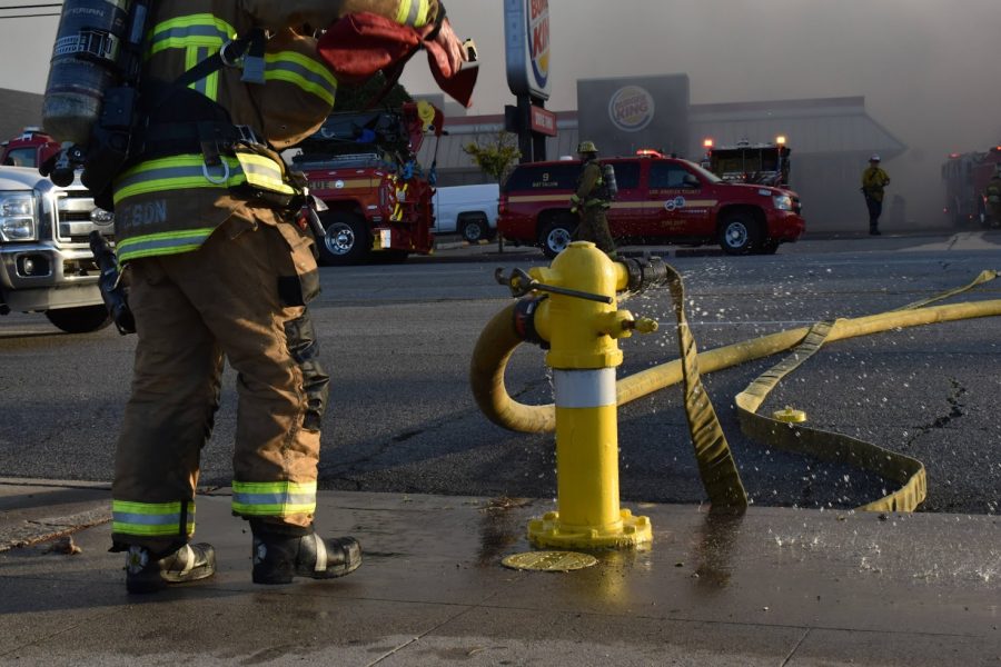 Fire hydrant feeds water into the hoses to elimante the blaze in Bellflower. Fire crews work coordinate to extinguish the flames on Nov. 9, 2021. 