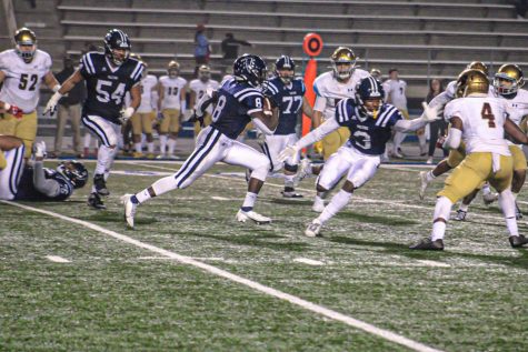 Sophomore running back No. 8, J’Lon Manning takes the handoff against Southwestern’s defense in the second quarter alongside Sophomore wide receiver No. 3, DeJour Smith out in front lead blocking. Manning finished with 11 carries for 82 yards against the Jaguars on Nov. 20, 2021. 