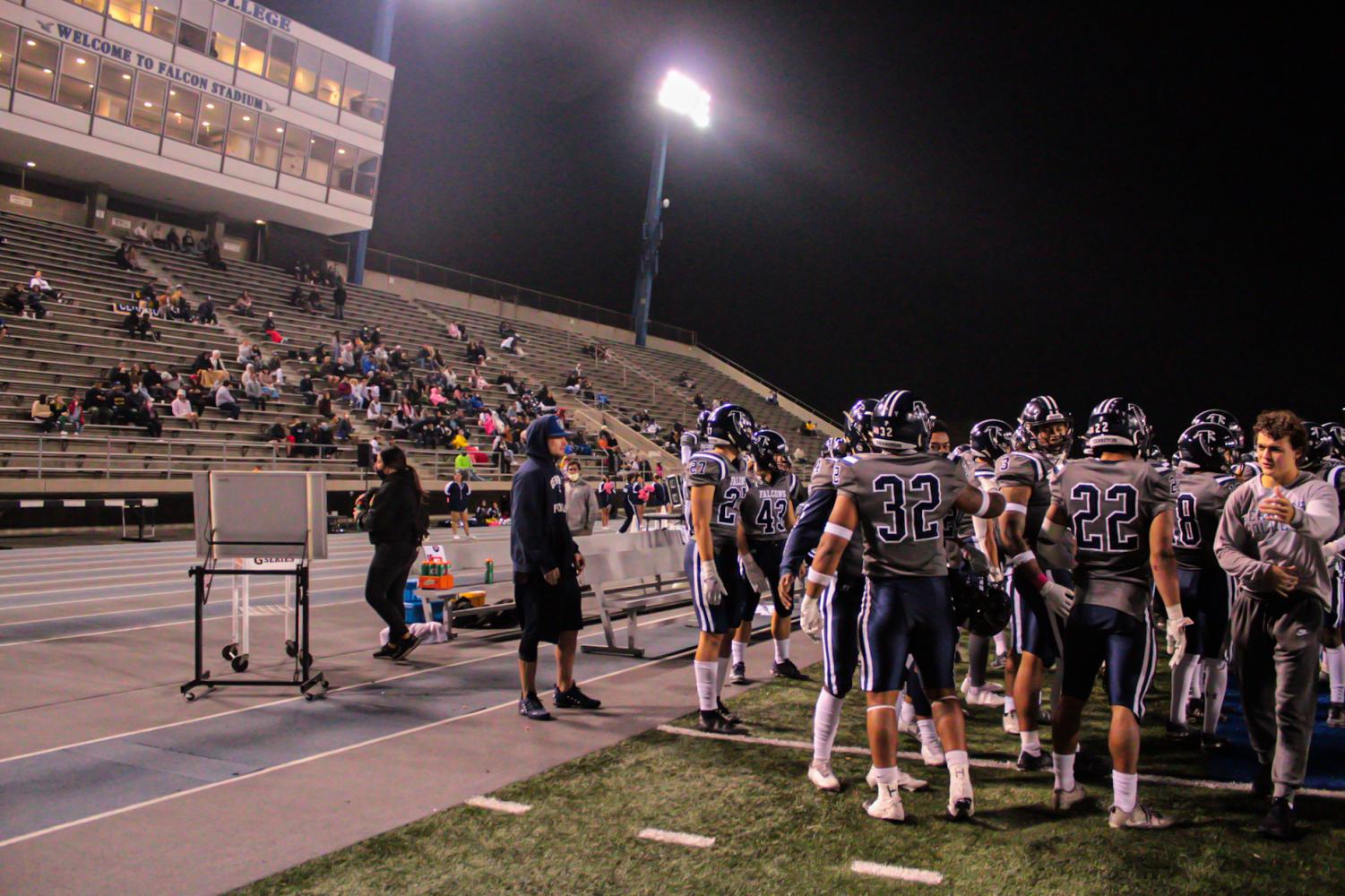 The Cerritos sideline as the defense rest after coming off the field late in the fourth quarter. The team can be seen excited to see their offense attempt a comeback down by five points on Oct. 30, 2021. Photo by: Roman Acosta