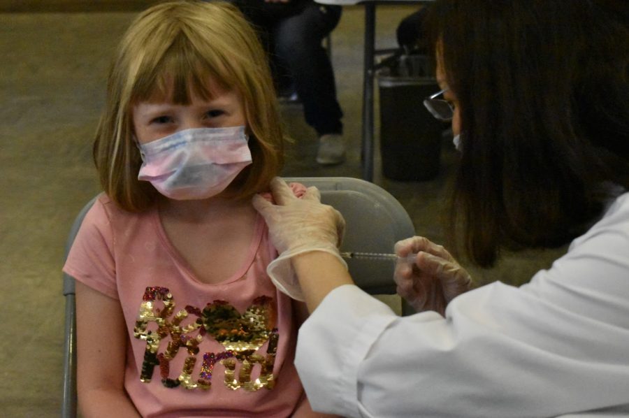 Ellie Samms, six, shows no fear as she glares at the camera and receives her first dose of the COVID-19 vaccine. NLMUSD hosted a vaccine clinic at Benton Middle School on Nov. 13, 2021. 