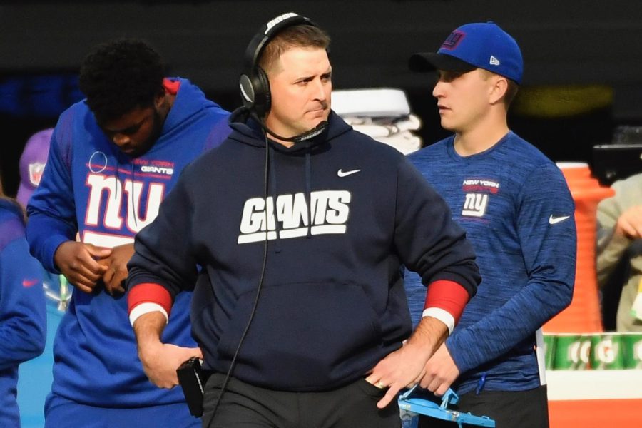 The man in the middle, with the headset on, is former Head Coach of the New York Giants, Joe Judge. We learned about his firing on January 11th, 2022, and was fired for his 4-13 season this year plus his 6-10 season last year (Pro Football Reference).