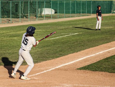 Freshman, shortstop, No. 15, Andy Vega hits a two run homer as he collects an RBI in the bottom of the seventh inning. Julian Francois and Vega puts the Falcons on the board 3-11 against the Dons on Feb. 8, 2022.