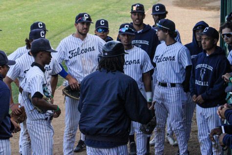 Coach Vic huddles up the team by the dugout before the bottom of the ninth inning uplifting them to keep their heads up. The Falcons held the Huskies in the top of the ninth at home on March. 3.