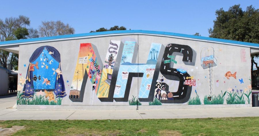A mural painted on the wall of a building on Norwalk High Schools campus abbreviating the schools name. 