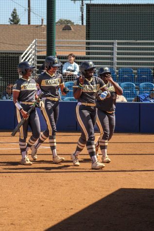 Los Angeles Harbor College scores on a grand slam in the top of the first against the Falcons with two outs. Seahawk runners celebrate at the plate and head to the dugout to celebrate alongside teammates as they take a 4-0 lead early at Nancy Kelly Field on April. 21, 2022.