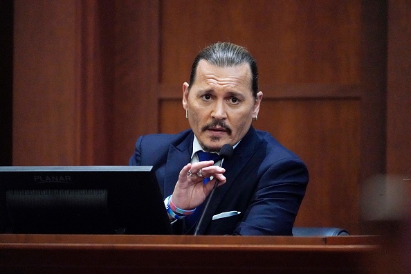 Actor Johnny Depp testifies in the courtroom at the Fairfax County Circuit Courthouse in Fairfax, Virginia, April 25, 2022. - Actor Johnny Depp sued his ex-wife Amber Heard for libel in Fairfax County Circuit Court after she wrote an op-ed piece in The Washington Post in 2018 referring to herself as a public figure representing domestic abuse. (Photo by Steve Helber / POOL / AFP) (Photo by STEVE HELBER/POOL/AFP via Getty Images)