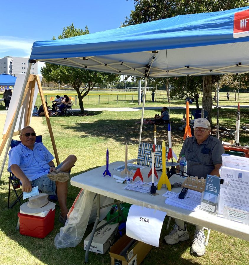 Martin Bowitz, the person on the right, and his friend set up their own booth to sell different wooden rockets. 
