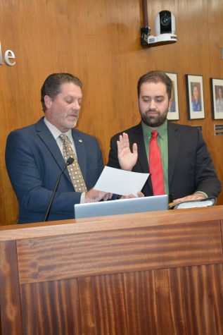 Trustee Zurich Lewis being sworn in by father and La Mirada City Council member John Lewis. Photo credit: Miya Walker, Public Affairs