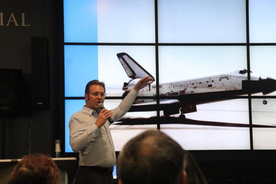 Executive director Ben Dikow walks visitors through the process of designing a NASA space shuttle.