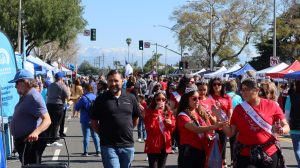 Large crowds of visitors walking through the Downey Street Fair and stopping at some of the booths, March 18.