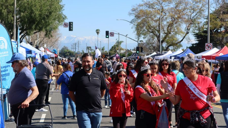 Large crowds of visitors walking through the Downey Street Fair and stopping at some of the booths, March 18.