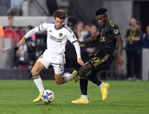 LOS ANGELES, CA - OCTOBER 20: Riqui Puig #6 of Los Angeles Galaxy controls the ball against Jose Cifuentes #20 of Los Angeles FC during the first half of the Western Conference Semifinals of 2022 MLS Cup playoffs at Banc of California Stadium on October 20, 2022 in Los Angeles, California. 