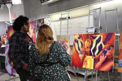 Risa Sero explaining her artwork to a guest on March 29 at Cerritos College.