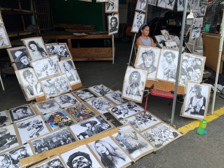 Santa Fe Springs art work of music artist from the past and present with one of the sellers in the background. 