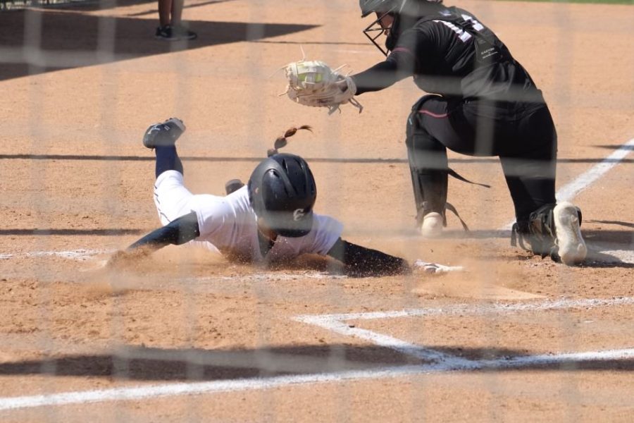 Sophomore center fielder Alyssa Capps slides home with two outs in the bottom of the second inning, which was called out by the umpires.