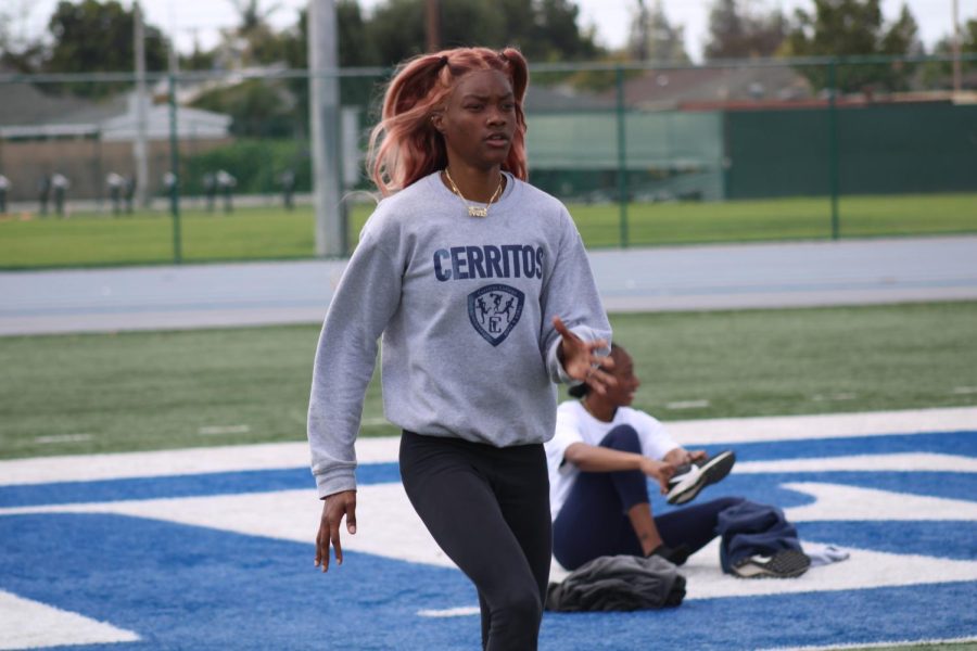 Rionna RiRi Wallace is doing stretching drills to get her legs ready to run across the football field on March 27.