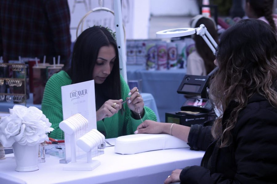 Dreamer Jewels owner preparing to fuse bracelet together with laser for client. 