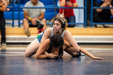 160-pounder Sianna Verdugo locks onto the opponents arm as she looks intently at her coach during the CCCAA State Championship game. 