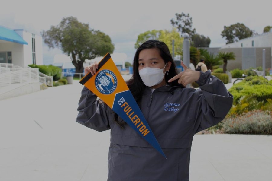 Vyanh Tran a business major excitedly poses with a pennant from CSUF Photo credit: Sophia Castillo