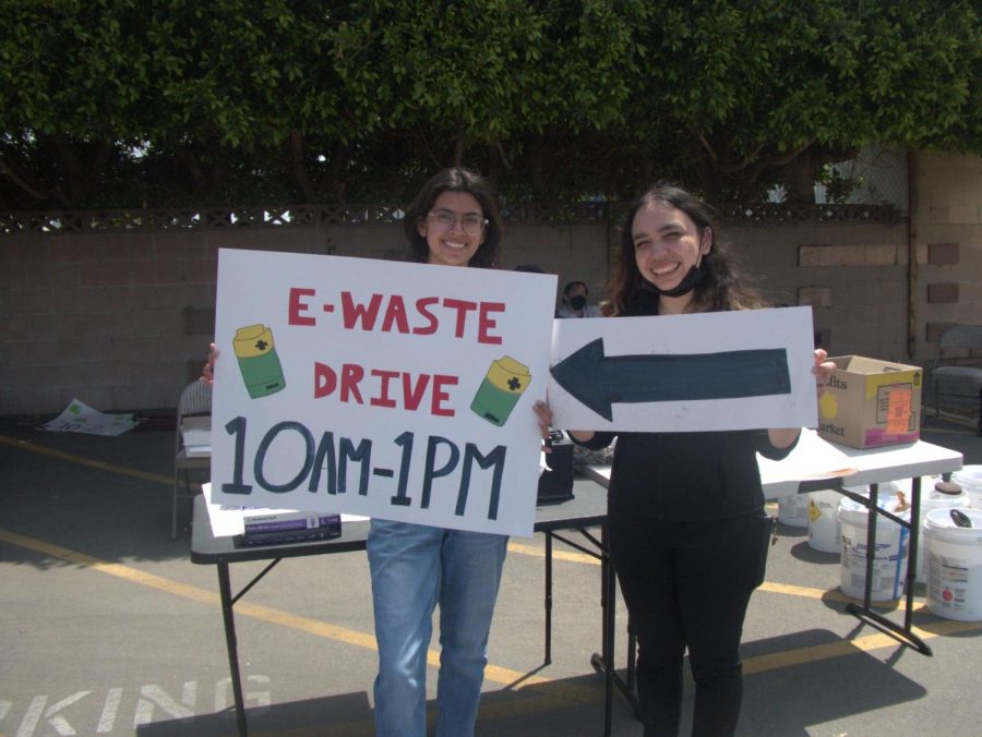 The two volunteers holding up the signs that help guide the cars in the right direction. Photo credit: Susan Romero