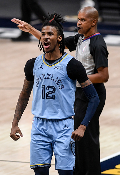 DENVER, CO - APRIL 19: Ja Morant (12) of the Memphis Grizzlies celebrates a clutch three against the Denver Nuggets during the first overtime at Ball Arena on Monday, April 19, 2021. 