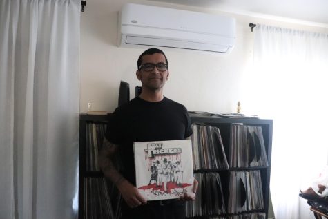 Javier Arellano, holding the vinyl Ultra Punk Droogs by punk band the Hat Trickers. 