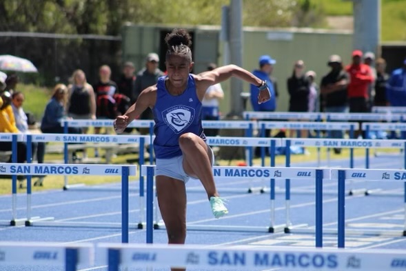 Jazzmine Davis jumps over hurdles throughout her race as she looks to win more records for Cerritos College. 
