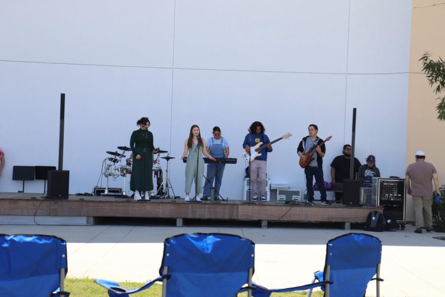 The band Commercial Music Ensembles performed at the Earth Day Festival, playing well-known pop hits. 