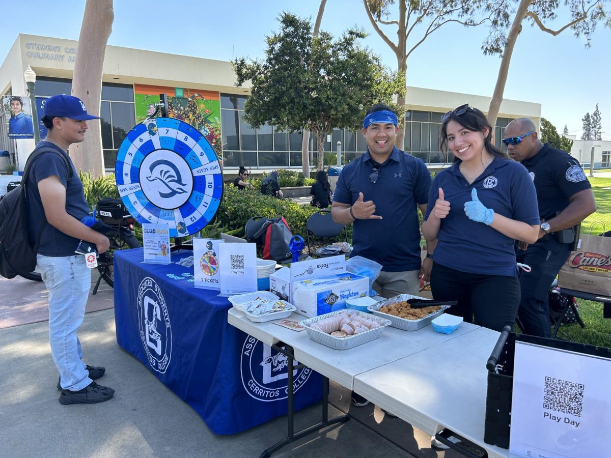 Staff members of the ASCC program welcoming students with a smile and some Cane's.