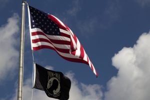 The American flag swaying back and forth above a POW-MIA flag.